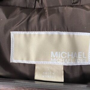 Woman’s brown Michael Kors jacket size large.